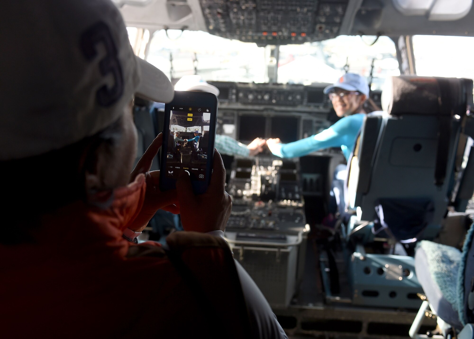 Children pretend to fly, a U.S. Air Force C-17 Globemaster III cargo aircraft, assigned to the 97th Air Mobility Wing, while being photographed by their mother during the 2016 Stuart Air Show, Nov. 5, 2016 at Stuart, Florida. The C-17 was set up as a static display during the air show to help educate attendees about its capabilities and the 97th AMW training mission. (U.S. Air Force photo by Senior Airman Franklin R. Ramos/Released)