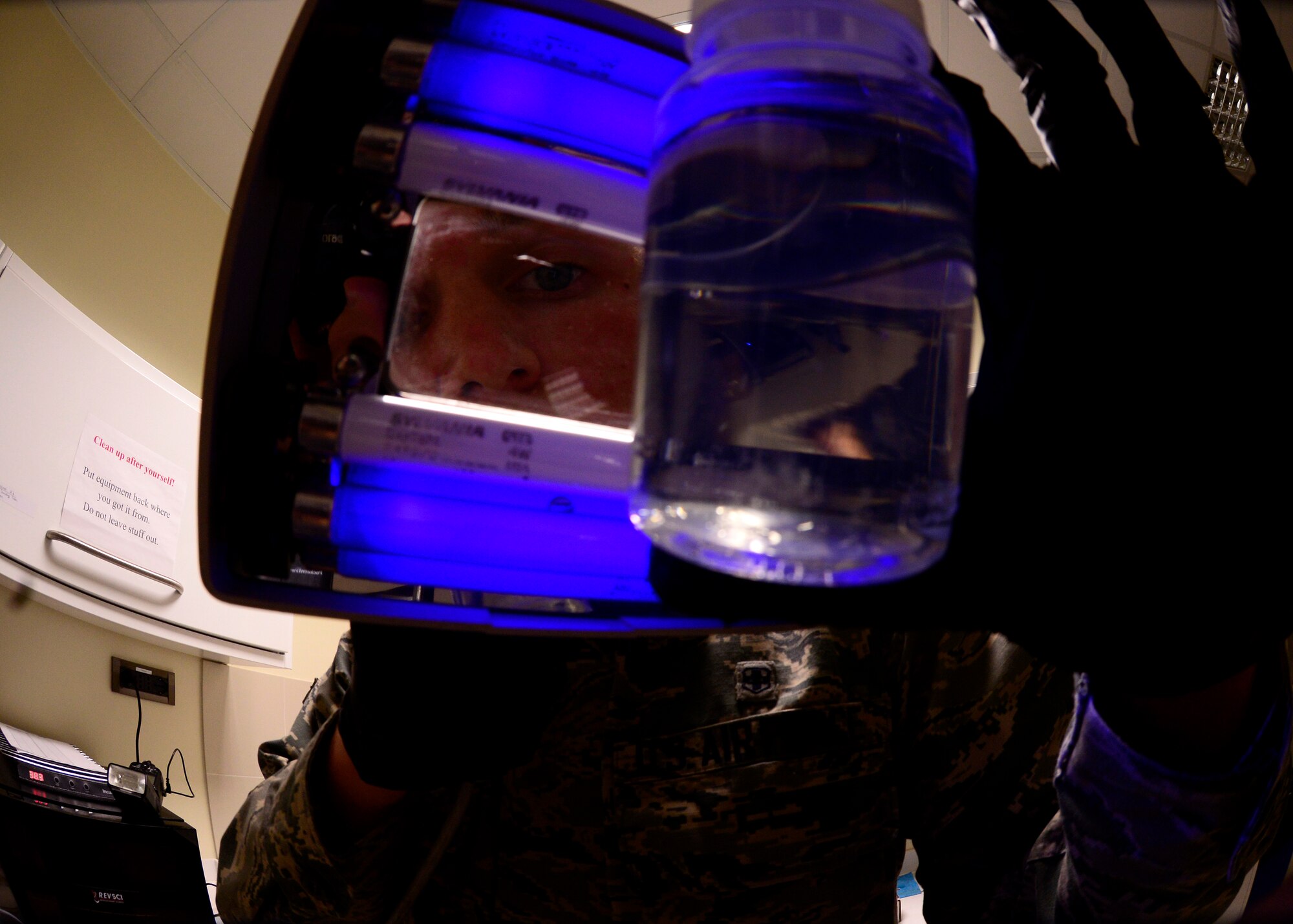 Airman 1st Class Jacob Blankenship, 31st Aerospace Medicine Squadron Bioenvironmental Engineering technician, uses ultra-violet light to examine a water sample at Aviano Air Base, Italy on Nov. 3, 2016. A UV light is one of several tools used to check water samples for harmful substances. (U.S. Air Force photo by Senior Airman Cary Smith)