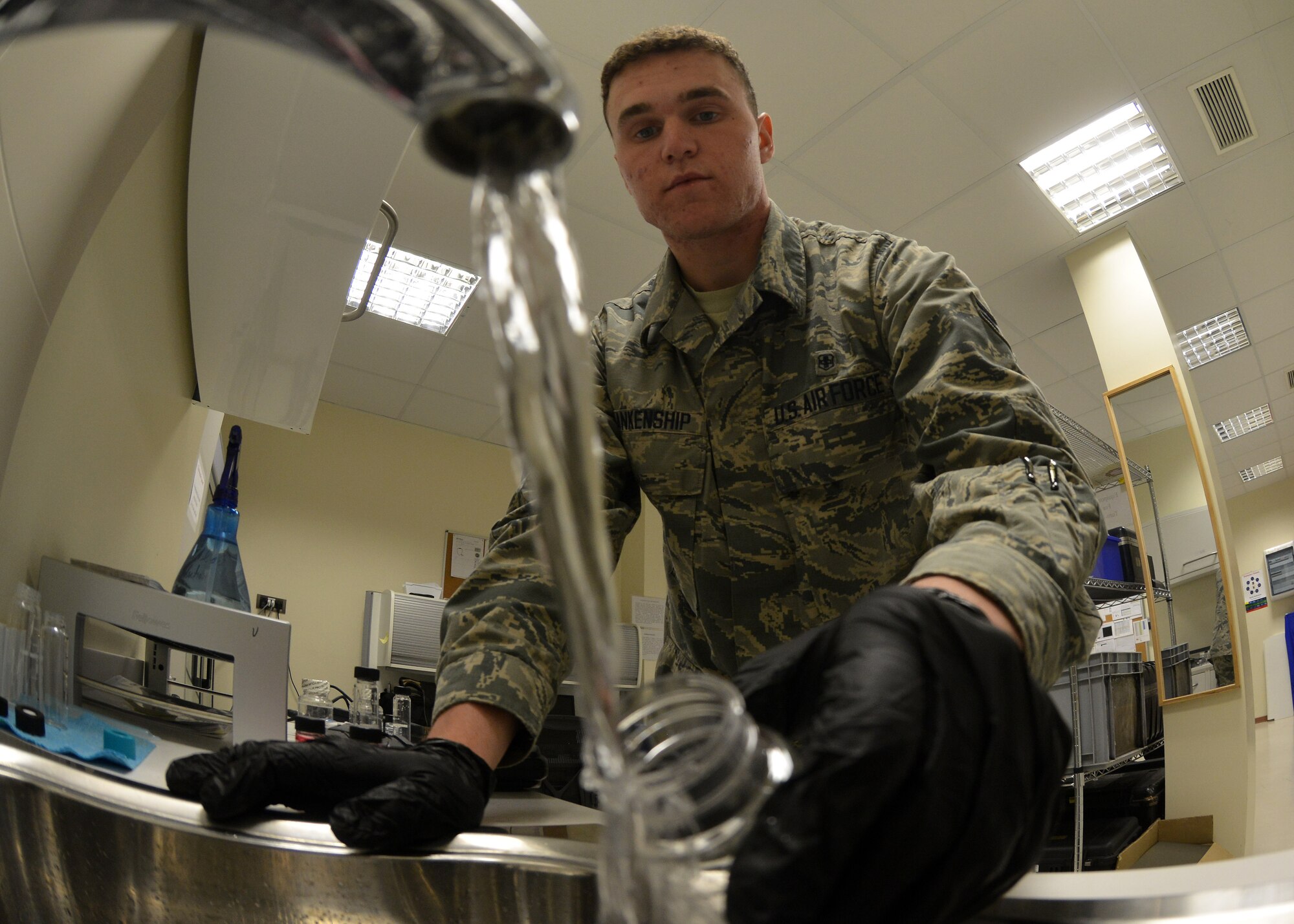 Airman 1st Class Jacob Blankenship, 31st Aerospace Medicine Squadron Bioenvironmental Engineering technician, fills a container to conduct a water safety test at Aviano Air Base, Italy on Nov. 3, 2016. The test was performed to ensure there were no harmful chemicals in the water. (U.S. Air Force photo by Senior Airman Cary Smith)
