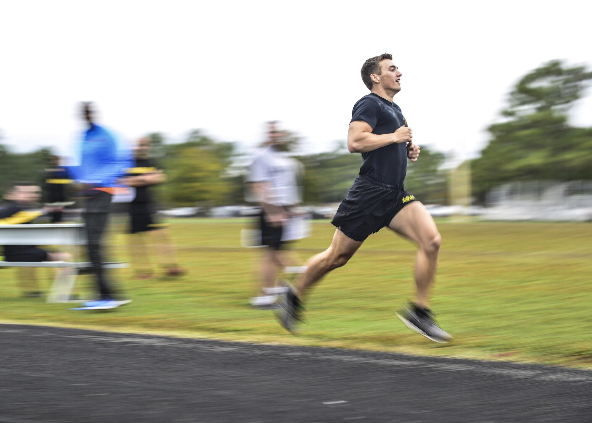 An U.S. Army Soldier sprints the 1,000 meter run, two and a half laps on the track, during the German Armed Forces Badge for military Proficiency event at Joint Base Langley-Eustis, Va., Nov. 1, 2016.  The runner starts at the 200-meter mark and must run two complete laps of the race, the runner’s time is recorded to the second. There is a bronze, silver and gold ranking system used from the total of all six events.  (U.S. Air Force photo/Tech Sgt. Daylena S. Ricks)