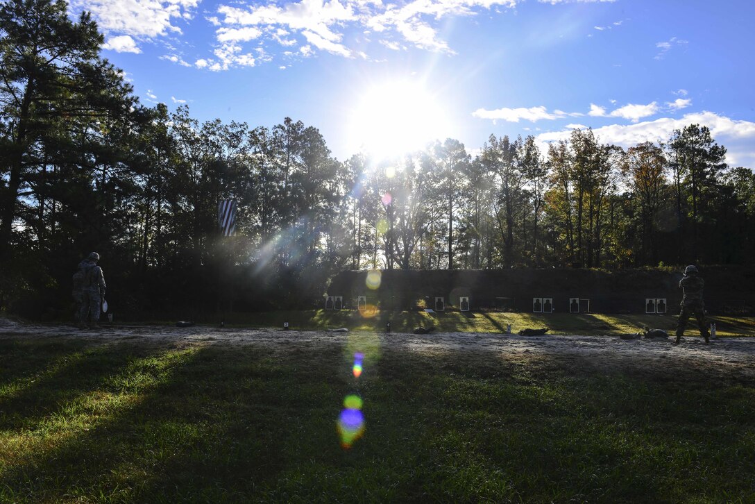 U.S. Air Force Airmen, U.S. Army Soldiers and U.S. Navy Sailors perform the pistol exercise in the standing unsupported position during the German Armed Forces Badge for military Proficiency event at Joint Base Langley-Eustis, Va., Nov. 4, 2016.  The GAFBP event consists of six events:  Basic fitness test; 11 by 10 sprint/flexed-arm hang/1,000-meter run, 100 meter swim, first-aid test, nuclear, biological, chemical evaluation, pistol qualification and a road march. (U.S. Air Force photo/Tech Sgt. Daylena S. Ricks)