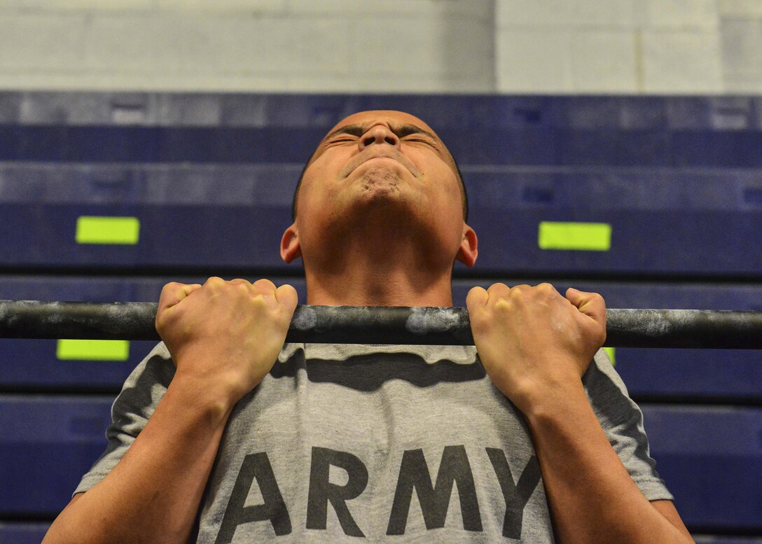 An U.S. Army Soldier performs a flexed-arm hang during the German Armed Forces Badge for military Proficiency at Joint Base Langley-Eustis, Va., Nov. 1, 2016.  The GAFPB flexed-arm hang is just one of three events that make up the basic fitness test; five second hold is the minimum requirement to pass.  (U.S. Air Force photo/Tech Sgt. Daylena S. Ricks)