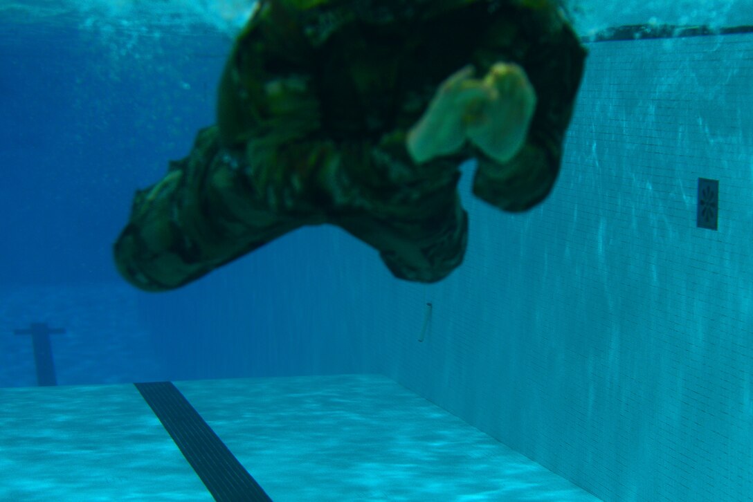 An U.S. Army Soldier dives into a pool for the 100-meter swim during the German Armed Forces Badge for military Proficiency event at Joint Base Langley-Eustis, Va., Nov. 2, 2016.  The 100-meter swim in uniform is one of six GAFPB events and must be completed within four minutes. (U.S. Air Force photo/Tech Sgt. Daylena S. Ricks)