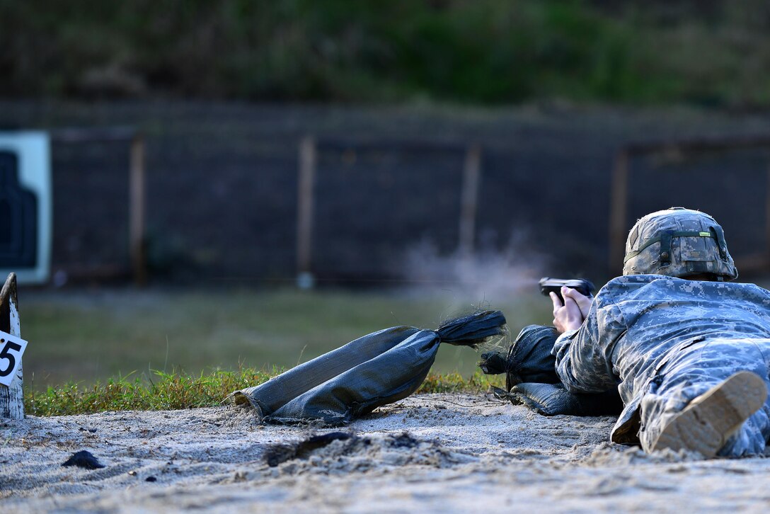 An U.S. Army Soldier fires a 9 mm Beretta automatic pistol in the prone unsupported position during the German Armed Forces Badge for military Proficiency event at Joint Base Langley-Eustis, Va., Nov. 4, 2016. The pistol exercise is one of six GAFPB events, members fire two bullets while performing three different shooting positions, aiming to hit the target. (U.S. Air Force photo/Tech Sgt. Daylena S. Ricks)