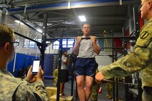 U.S. Air Force Airman 1st Class Derek Siefert, 633rd Air Base Wing, Public Affairs photojournalist performs a flexed-arm hang during the German Armed Forces Badge for military Proficiency at Joint Base Langley-Eustis, Va., Nov. 1, 2016.  The GAFPB flexed-arm hang is just one of three events that make up the basic fitness test; five second hold is the minimum requirement to pass.  The other two events are: 11 by 10-meter sprint test finishing within 60 seconds and a 1,000 meter run finishing within six minutes and 30 seconds.  (U.S. Air Force photo/Tech Sgt. Daylena S. Ricks)