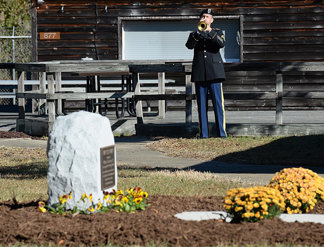 An U.S. Army Soldier plays Taps to honor William J. Franssen, Sr. during an unveiling ceremony at Joint Base Langley-Eustis, Va., Nov. 8, 2016. The Fort Eustis mini park was named to recognize Franssen’s 40 years of service to Morale, Welfare and Recreation programs. (U.S. Air Force photo by Staff Sgt. Teresa J. Cleveland)