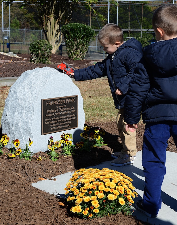 William J. Franssen Sr.’s grandchildren play with toys on a memorial recognizing Franssen after a ceremony at Joint Base Langley-Eustis, Va., Nov. 8, 2016. The Fort Eustis mini park has been renamed Franssen Park and includes mini-golf and a go-cart track. (U.S. Air Force photo by Staff Sgt. Teresa J. Cleveland)