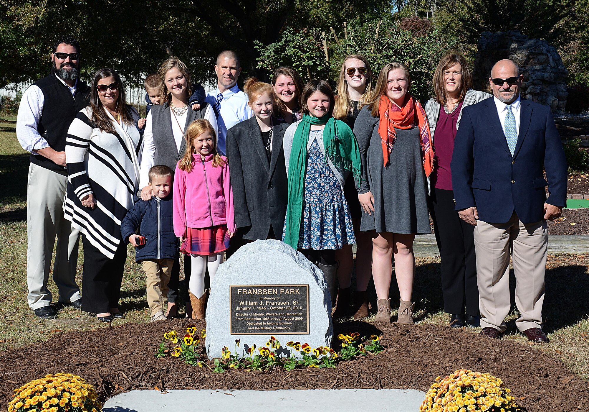 Family members of William J. Franssen, Sr. gather around his memorial after an unveiling ceremony at Joint Base Langley-Eustis, Va., Nov. 8, 2016. During his 40 years of service to Morale, Welfare and Recreation programs, Franssen worked to improve the quality of life for U.S. Army Soldiers and their families.(U.S. Air Force photo by Staff Sgt. Teresa J. Cleveland)