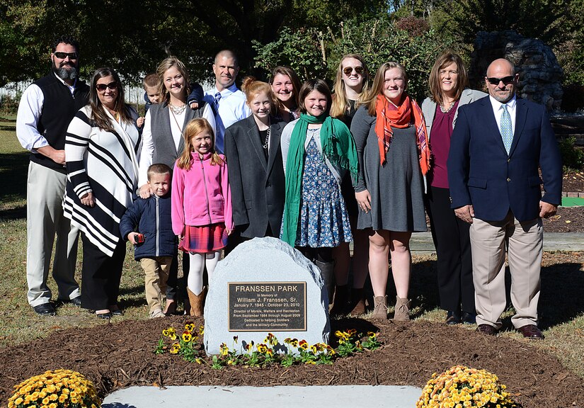 Family members of William J. Franssen, Sr. gather around his memorial after an unveiling ceremony at Joint Base Langley-Eustis, Va., Nov. 8, 2016. During his 40 years of service to Morale, Welfare and Recreation programs, Franssen worked to improve the quality of life for U.S. Army Soldiers and their families.(U.S. Air Force photo by Staff Sgt. Teresa J. Cleveland)