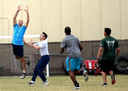 A 59th Medical Operations Group team member reaches over the competition to catch an overthrown Frisbee during the ultimate Frisbee challenge on Joint Base San Antonio-Lackland, Texas, Nov. 4. The 59th MDOG won first place in the Ultimate Frisbee challenge. (U.S. Air Force photo/Staff Sgt. Kevin Iinuma)