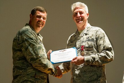315th Airlift Wing Commander, Col. Gregory Gilmour presents a Meritorious Service Medical certificate to departing 315th Maintenance Group Commander, Col. Richard Gay.  Nov. 6.  Members of the 315th Maintenance Group welcomed the new commander to their unit during a change of command ceremony at Joint Base Charleston, South Carolina. Col. Richard Gay relinquished his command of seven years to Col. Sharon Johnson as Gay prepares for his retirement later in the year. (U.S. Air Force Photo by Senior Airman Jonathan Lane)
