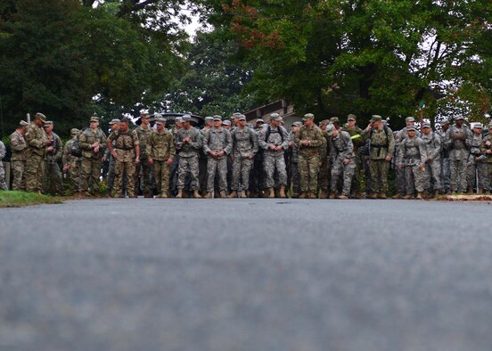 U.S. Air Force Airmen, U.S. Army Soldiers, U.S. Navy Sailors put on their rucks for the road march during the German Armed Forces Badge for military proficiency event at Joint Base Langley-Eustis, Va., Nov. 3, 2016. The GAFPB road march is based on completion time and distance. To earn gold in this event the member must march 12 kilometers within 120 minutes, silver, nine kilometer within 90 minutes, bronze, six kilometers within 60 minutes. (U.S. Air Force photo/Tech. Sgt. Katherine Ward)