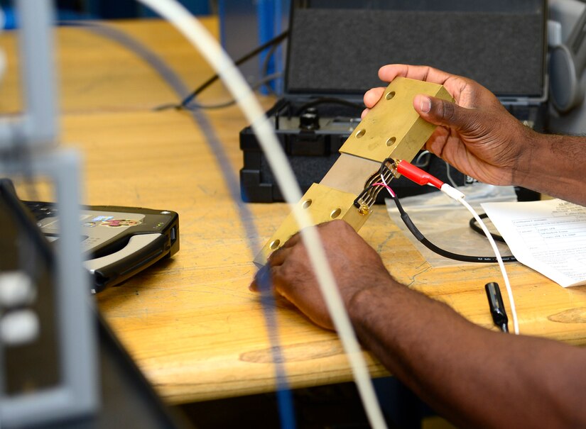 Ernest Triplett, 1st Maintenance Squadron electronics technician, tests a shunt with the resistance measurement system at Joint Base Langley-Eustis, Va., Nov. 3, 2016. The resistance measurement system reads the voltage given off by the equipment and calibrates it to the proper voltage needed if the equipment is off. (U.S. Air Force photo by Airman 1st Class Kaylee Dubois)