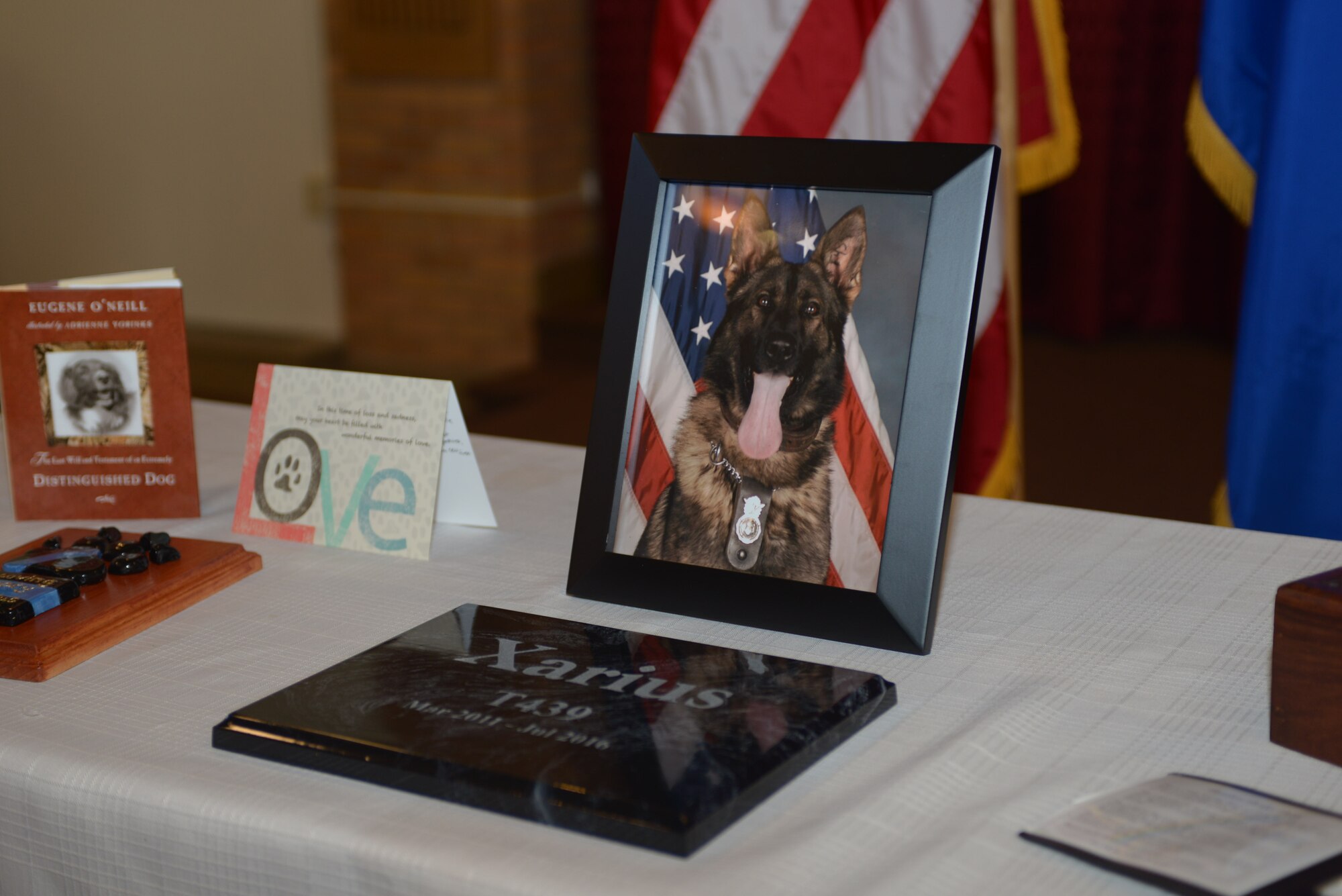A photo of Xarius, a military working dog assigned to the 28th Security Forces Squadron, rests on a table during his funeral in the Freedom Chapel at Ellsworth Air Force Base, S.D., Nov. 4, 2016. Military working dogs, like any other service member, are honored for their dedication and service to their country. (U.S. Air Force photo by Airman 1st Class Donald C. Knechtel)
