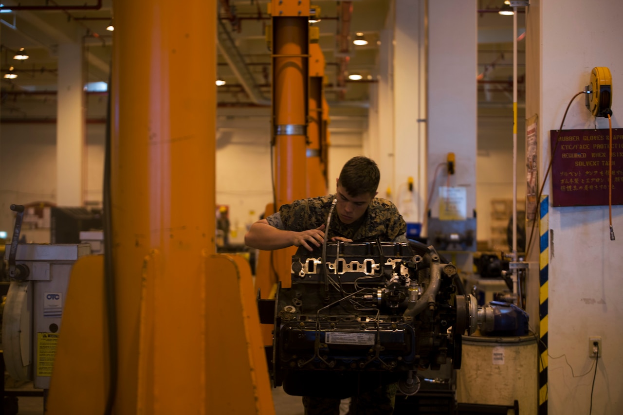 Marine Corps Cpl. Matthew A. Long turns a wrench on a Humvee engine at Camp Kinser, Okinawa, Japan, Oct. 25, 2016. Marine Corps photo by Lance Cpl. Nelson Duenas