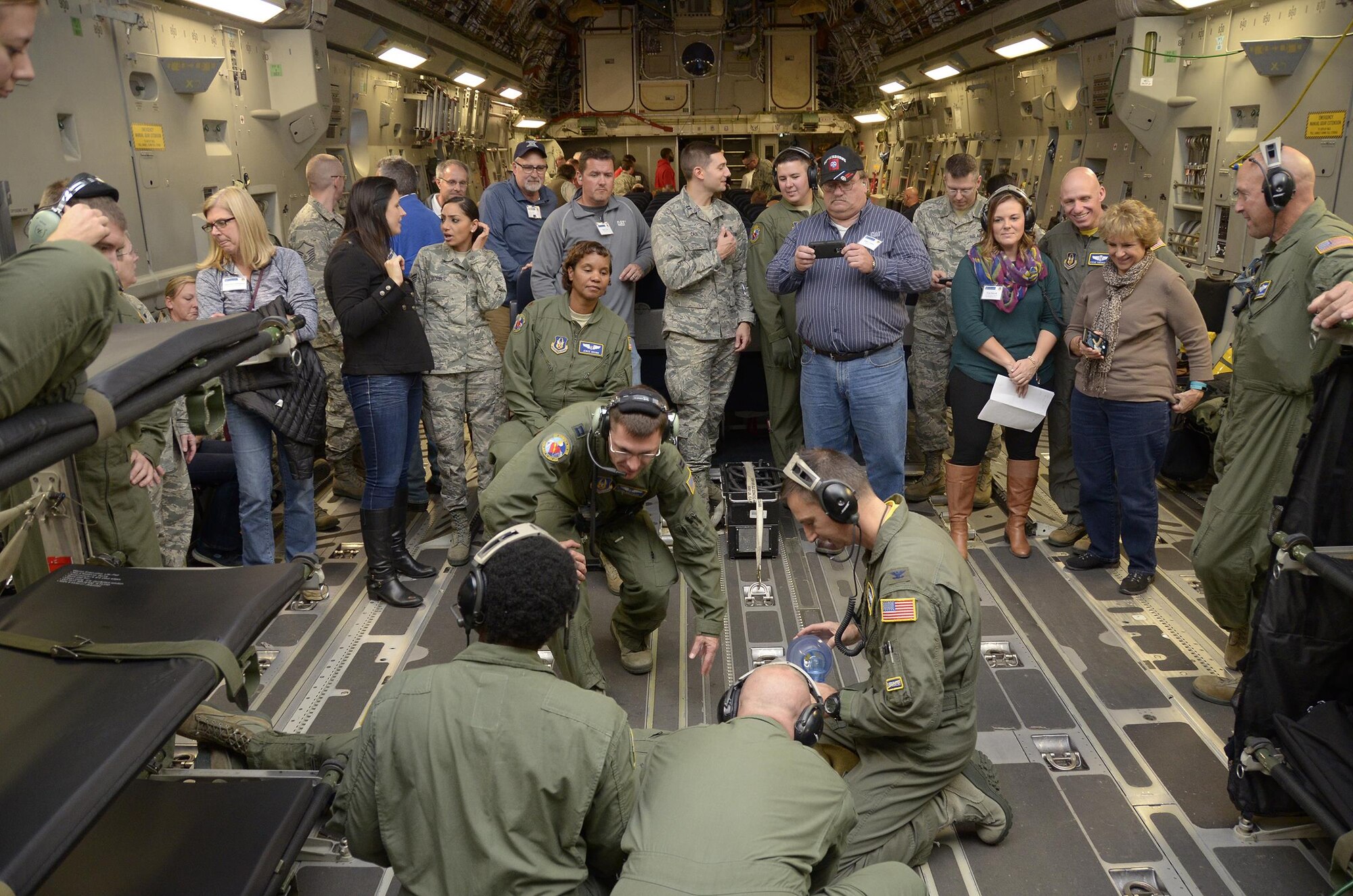 Employers participating in the 445th Airlift Wing Employers Day Nov. 5, 2016 watch a medical scenario performed by the 445th Aeromedical Evacuation Squadron during a C-17 Globemaster III flight. Approximately 70 employers and 35 reservists enjoyed breakfast and lunch, received a flight, participated in tours and demonstrations of the different jobs and training that their Air Force Reserve employees do when performing military service. The employers also received information about the Employer Support of the Guard and Reserve program. (U.S. Air Force photo/Staff Sgt. Joel McCullough)