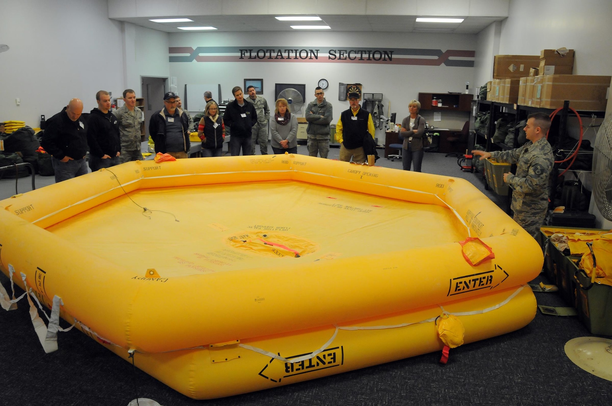 Staff Sgt. Tyler Deye, 445th Operations Support Squadron aircrew flight equipment journeyman, talks to employers about the purpose and use of a raft during a demonstration as part of the 445th Airlift Wing Employers Day Nov. 5, 2016. Approximately 70 employers and 35 reservists enjoyed breakfast and lunch, received a C-17 Globemaster III flight, participated in tours and demonstrations of the different jobs and training that their Air Force Reserve employees do when performing military service. The employers also received information about the Employer Support of the Guard and Reserve program. (U.S. Air Force photo/Tech. Sgt. Anthony Springer)