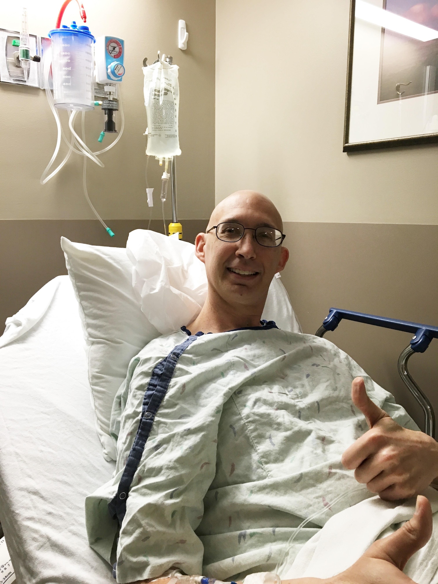 Maj. Brian Crawford gives the thumbs up after receiving cancer surgery at Anderson Medical Center in Cincinnati, because Wright-Patterson Medical Center did not have an orthopedic oncologist who could perform the surgery. He received his chemo treatments at the 88th Medical Center, however. (Courtesy photo)