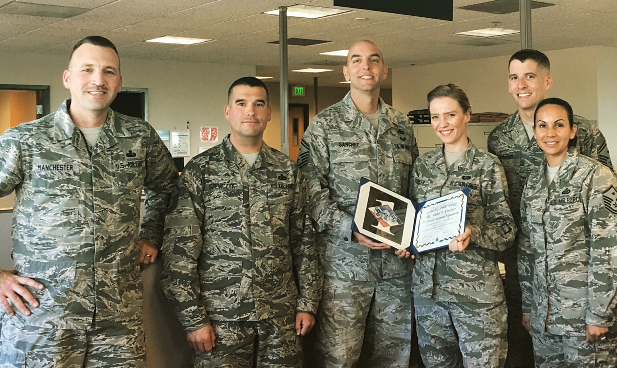 PETERSON AIR FORCE BASE, Colo.  –Airman 1st Class Ashley Zwicker, career development specialist for the 21st Force Support Squadron, is presented the Diamond Sharp Award by the Diamond Council at Peterson Air Force Base, Colo., Nov. 3, 2016. Zwicker received the award for supporting 28 wing units, one geographically separated unit and 52 tenant units, totaling more than 23,000 active duty military personnel. She is the base subject matter expert on retirements and administrative separations, and also works with the base commanders, first sergeants and JAG officers to ensure full compliance with all retirement, separation and assignment processes and procedures.  (Courtesy photo)

