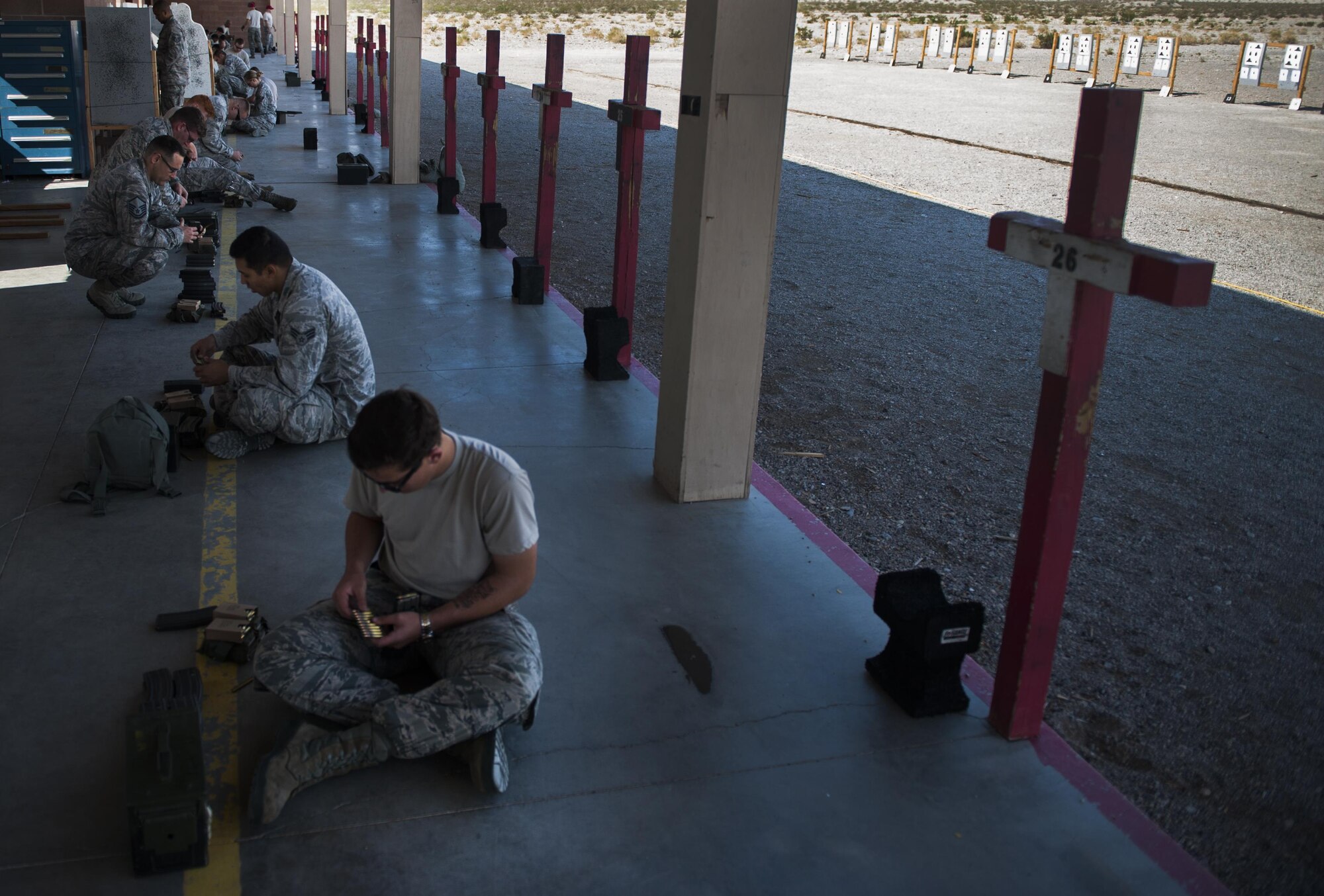 Airmen load ammunition during the 99th Security Force Squadron Combat Arms Training and Maintenance M4 carbine class on Nellis Air Force Base, Nev., Oct. 25, 2016. The 99th SFS CATM offer a wide variety of weapons classes, to prepare deploying Airmen for whatever real world scenario that may be ahead of them. (U.S. Air Force photo by Airman 1st Class Kevin Tanenbaum/Released)