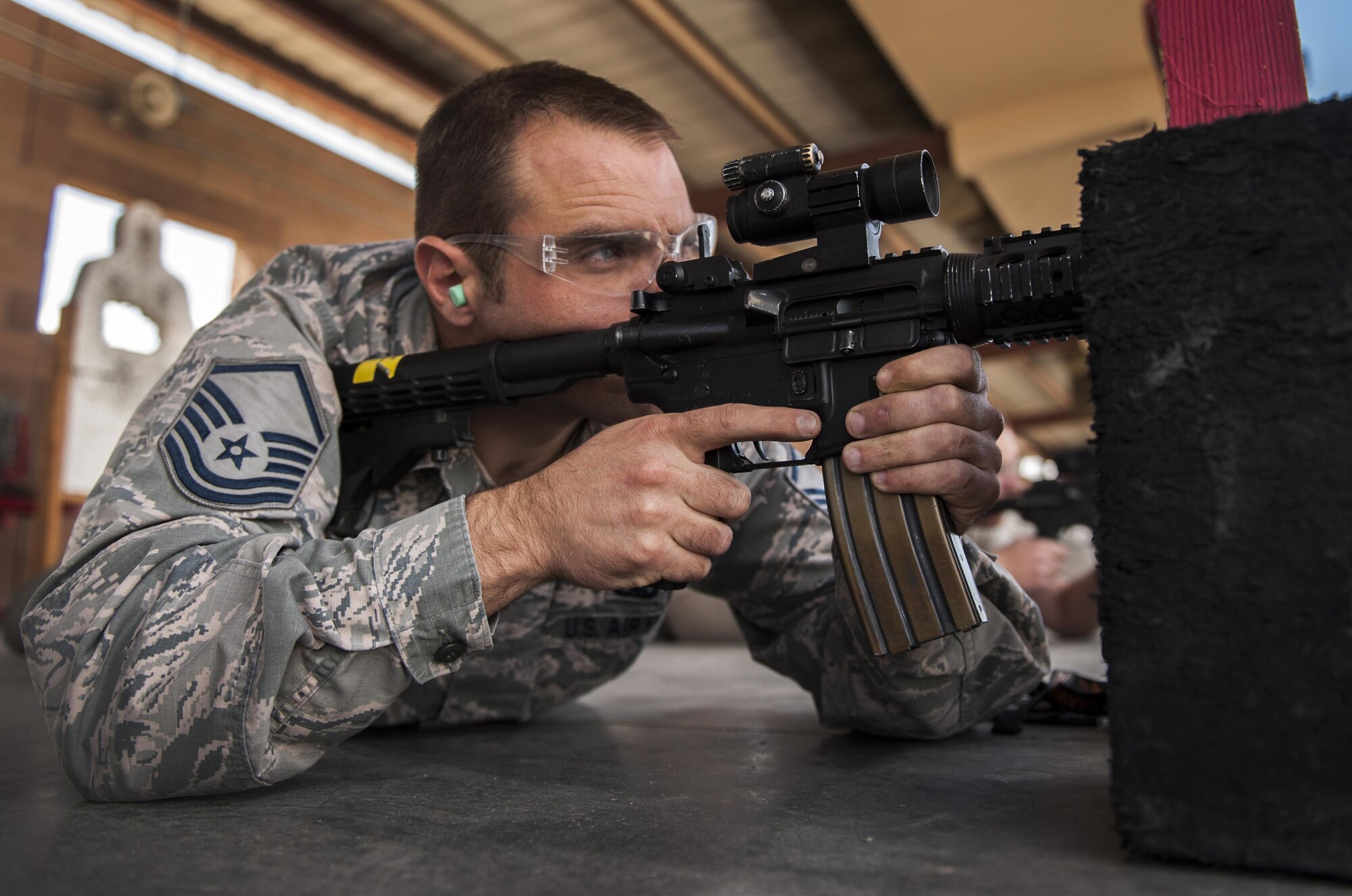 Master Sgt. Dennis Hutchinson, 57th Maintenance Group, fires an M4 carbine during a Combat Arms Training and Maintenance class on Nellis Air Force Base, Nev., Oct. 25, 2016. CATM classes are most associated with the opportunity to go the range and enhance skills with a weapon. (U.S. Air Force photo by Airman 1st Class Kevin Tanenbaum/Released)