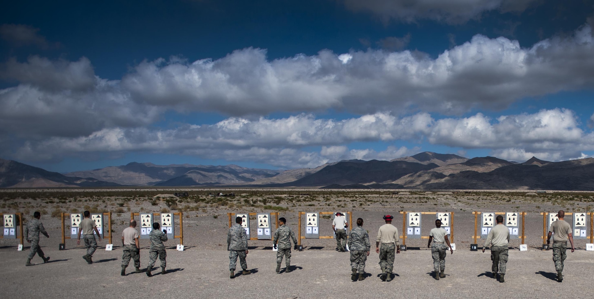 Airmen taking an M4 carbine Combat Arms Training and Maintenance class check their targets after a round of shooting on Nellis Air Force Base, Nev., Oct. 25, 2016. Once at the range, Airmen are given the opportunity to fire their weapon and familiarize themselves with the tools they will interact with daily while deployed. (U.S. Air Force photo by Airman 1st Class Kevin Tanenbaum/Released)