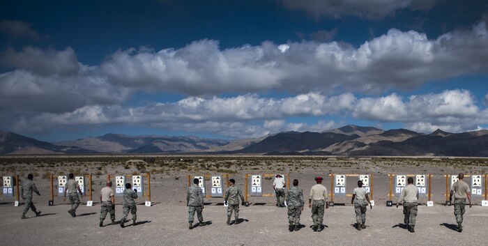 Airmen taking an M4 carbine Combat Arms Training and Maintenance class check their targets after a round of shooting on Nellis Air Force Base, Nev., Oct. 25, 2016. Once at the range, Airmen are given the opportunity to fire their weapon and familiarize themselves with the tools they will interact with daily while deployed. (U.S. Air Force photo by Airman 1st Class Kevin Tanenbaum/Released)