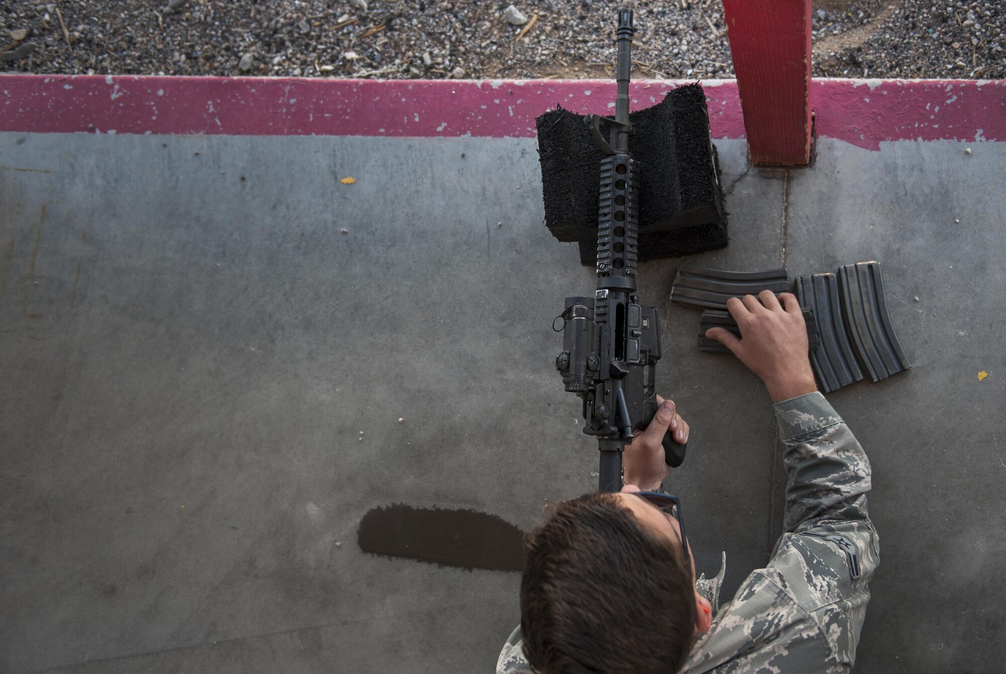 Airman 1st Class Levi Chamberlain, loads a new magazine during a Combat Arms Training and Maintenance M4 carbine class on Nellis Air Force Base, Nev., Oct. 25, 2016. CATM prepares Airmen if they need to use their weapon they will know how to use it properly and have a good chance to survive any battle they come across. (U.S. Air Force photo by Airman 1st Class Kevin Tanenbaum/Released)