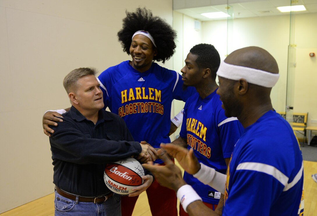 U.S. Air Force Col. Thomas Torkelson, left, 100th Air Refueling Wing commander, recieves an autographed basketball from Harlem Globetrotters’ Moose, Flip and Firefly, Nov. 4, 2016, at the Hardstand Fitness Center on RAF Mildenhall, England. The Harlem Globetrotters visited RAF Mildenhall to boost morale. (U.S. Air Force photo by Staff Sgt. Micaiah Anthony)