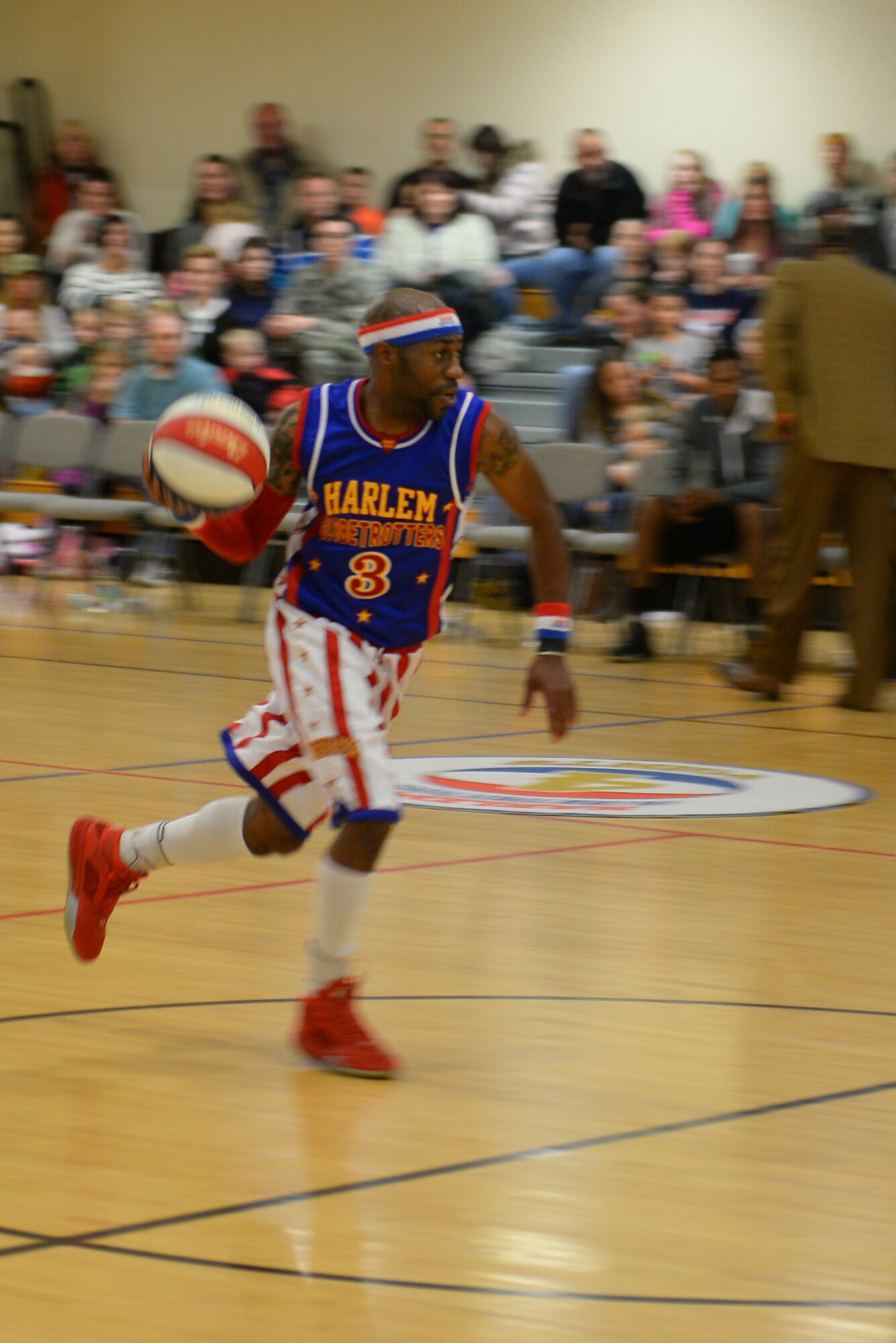 Harlem Globetrotters guard, Firefly, dribbles a basketball Nov. 4, 2016, at the Hardstand Fitness Center on RAF Mildenhall, England. The Harlem Globetrotters are an exhibition baseketball team that perform around the world. (U.S. Air Force photo by Staff Sgt. Micaiah Anthony)