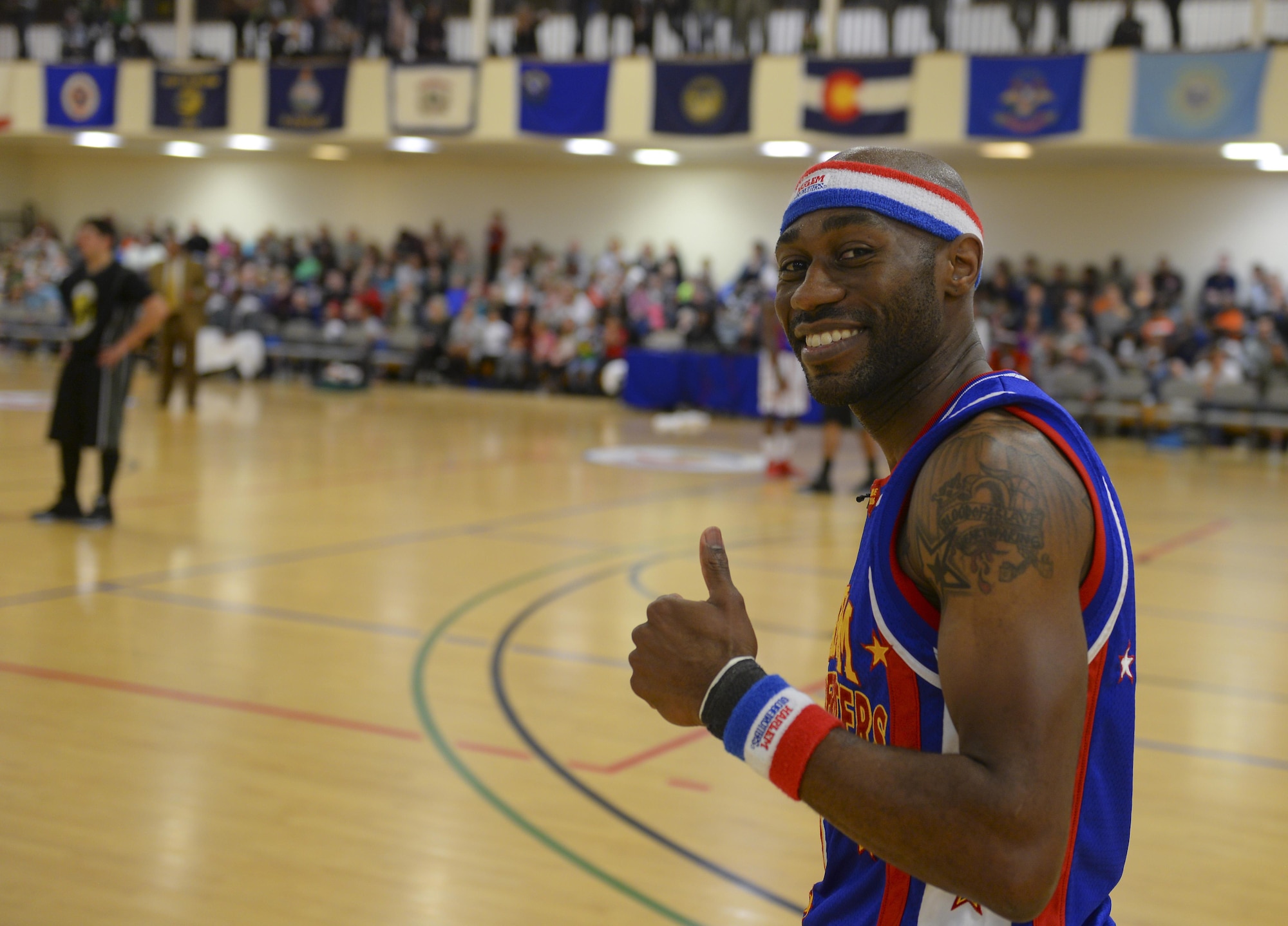 Harlem Globetrotters guard, Firefly, poses for a photo during a performance Nov. 4, 2016, at the Hardstand Fitness Center on RAF Mildenhall, England. The Harlem Globetrotters have been labeled goodwill ambassadors for their local and global community involvement and history of breaking down barriers. (U.S. Air Force photo by Staff Sgt. Micaiah Anthony)