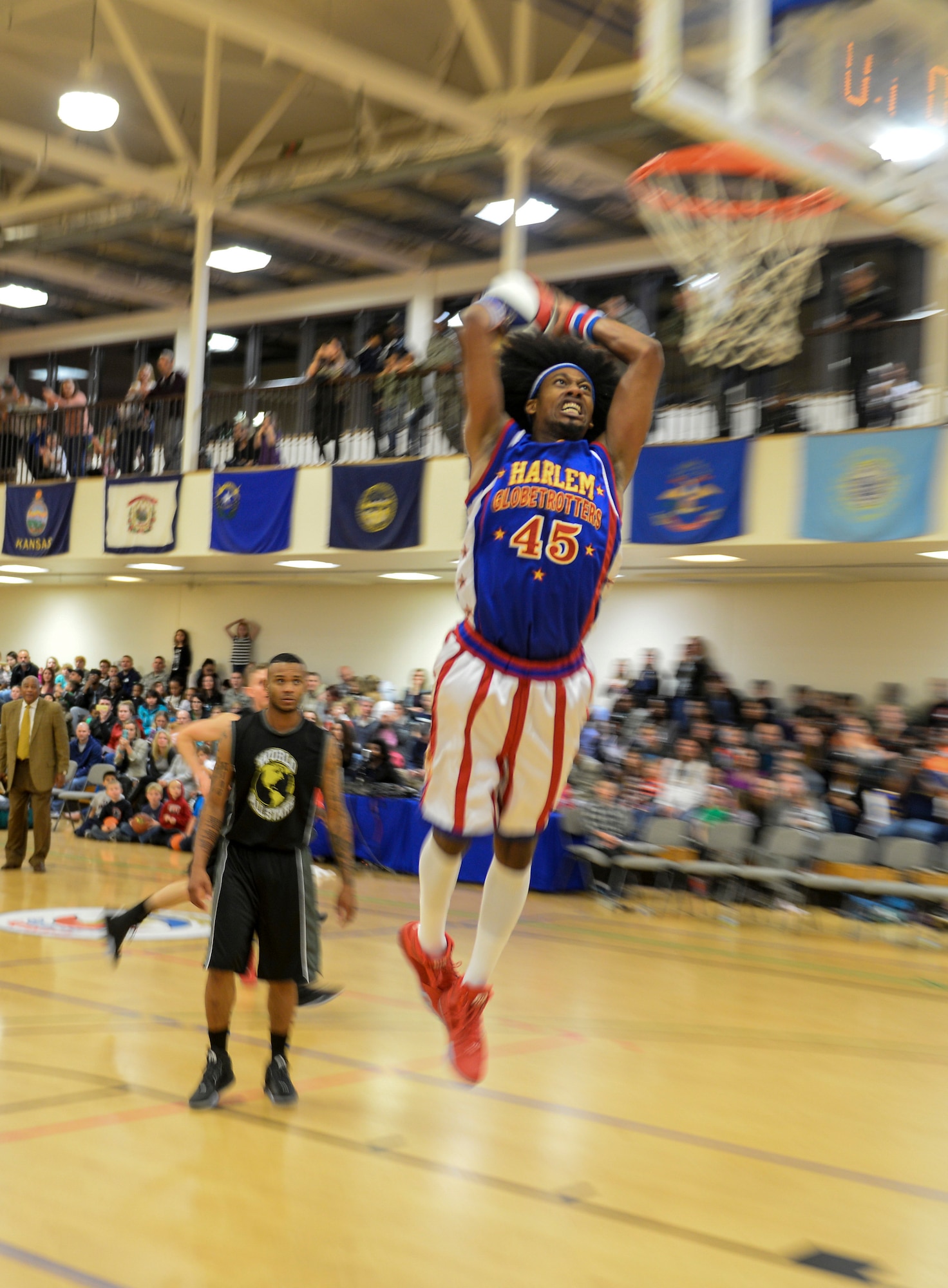 Harlem Globetrotters forward, Moose, makes the game winning dunk Nov. 4, 2016, at the Hardstand Fitness Center on RAF Mildenhall, England. The game was in overtime and this dunk lead the Globetrotters to victory. (U.S. Air Force photo by Staff Sgt. Micaiah Anthony)