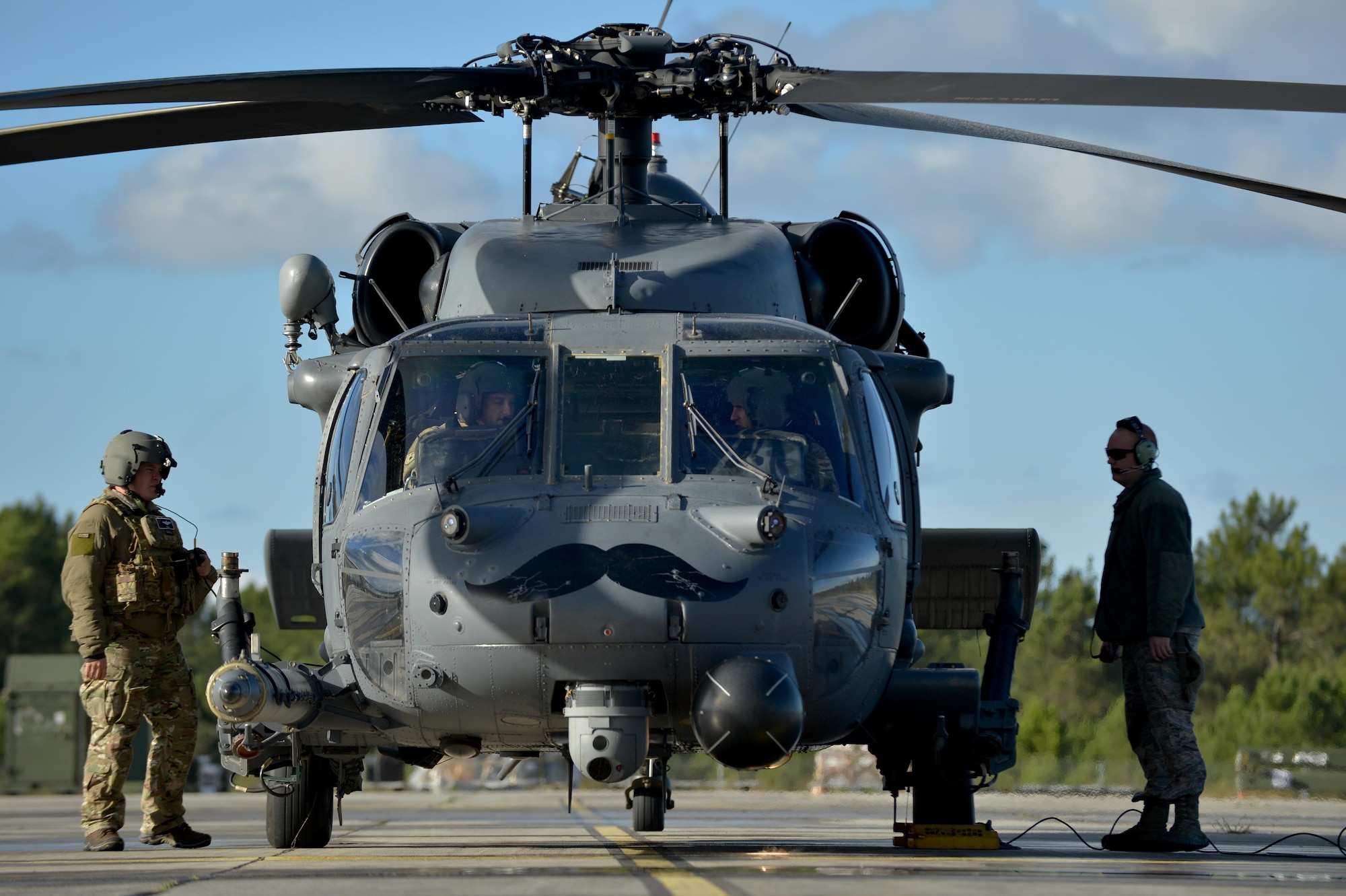 56th and 57th Rescue Squadron Airmen perform pre-flight checks on an HH-60G Pave Hawk prior to a flying mission Nov. 7 during Exercise Salamander at Cazaux Air Force Base, France. Two HH-60G Pave Hawk helicopters assigned to the 56th RQS and approximately 100 Airmen are involved in the joint training exercise with French air force members and helicopters. (U.S. Air Force photo/Master Sgt. Eric Burks)