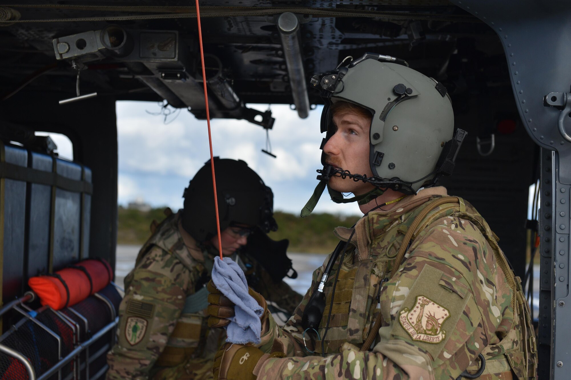 A special mission aviator prepares a rescue hoist during pre-flight checks prior to a flying mission Nov. 7 during Exercise Salamander at Cazaux Air Force Base, France. Participation in joint exercises allows U.S. forces to bolster relationships and interoperability with international partners. (U.S. Air Force photo/Master Sgt. Eric Burks)