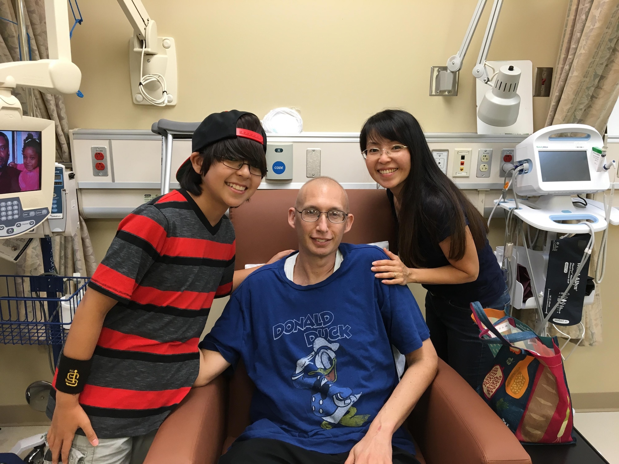 Maj. Brian Crawford receives treatment at the 88th Medical Group with his youngest son, Kyle, and his wife, Masako, providing encouragement. (Courtesy photo)