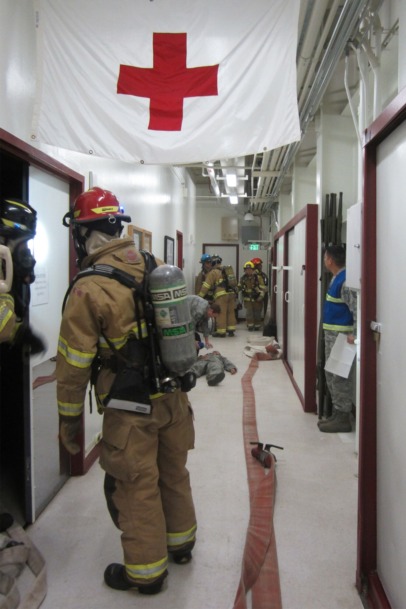 CHEYENNE MOUNTAIN AIR FORCE STATION, Colo. – Firefighters from the Cheyenne Mountain Air Force Station Fire Department attend to a simulated smoke inhalation victim during a fire scenario for the Condor Crest exercise at CMAFS, Colo., Nov. 1, 2016. This was just one scenario which was played out during the wing-wide exercise. (Courtesy photo)