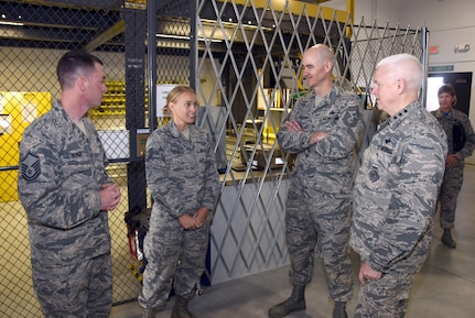 Lt. Gen. L. Scott Rice, Air National Guard director, and Chief Master Sgt. Ronald C. Anderson, Air National Guard command chief master sergeant, visit with Master Sgt. Luke Roorda and Tech. Sgt Whitney Fester, 114th Aircraft Maintenance Squadron, during a tour of the 114th Fighter Wing, Nov. 5., 2016. Rice and Anderson also participated in a recognition ceremony during their visit to Joe Foss Field, S.D.