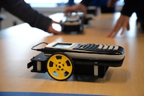 A calculator-controlled robot waits to race with other robots, which were programmed by 10th-graders from Wootton High School’s Academy of Information Technology during a science, technology, engineering and math (STEM) event at Naval Surface Warfare Center, Carderock Division Nov. 2, 2016 in West Bethesda, Md. U.S. Navy photo by Kelley Stirling (Released)