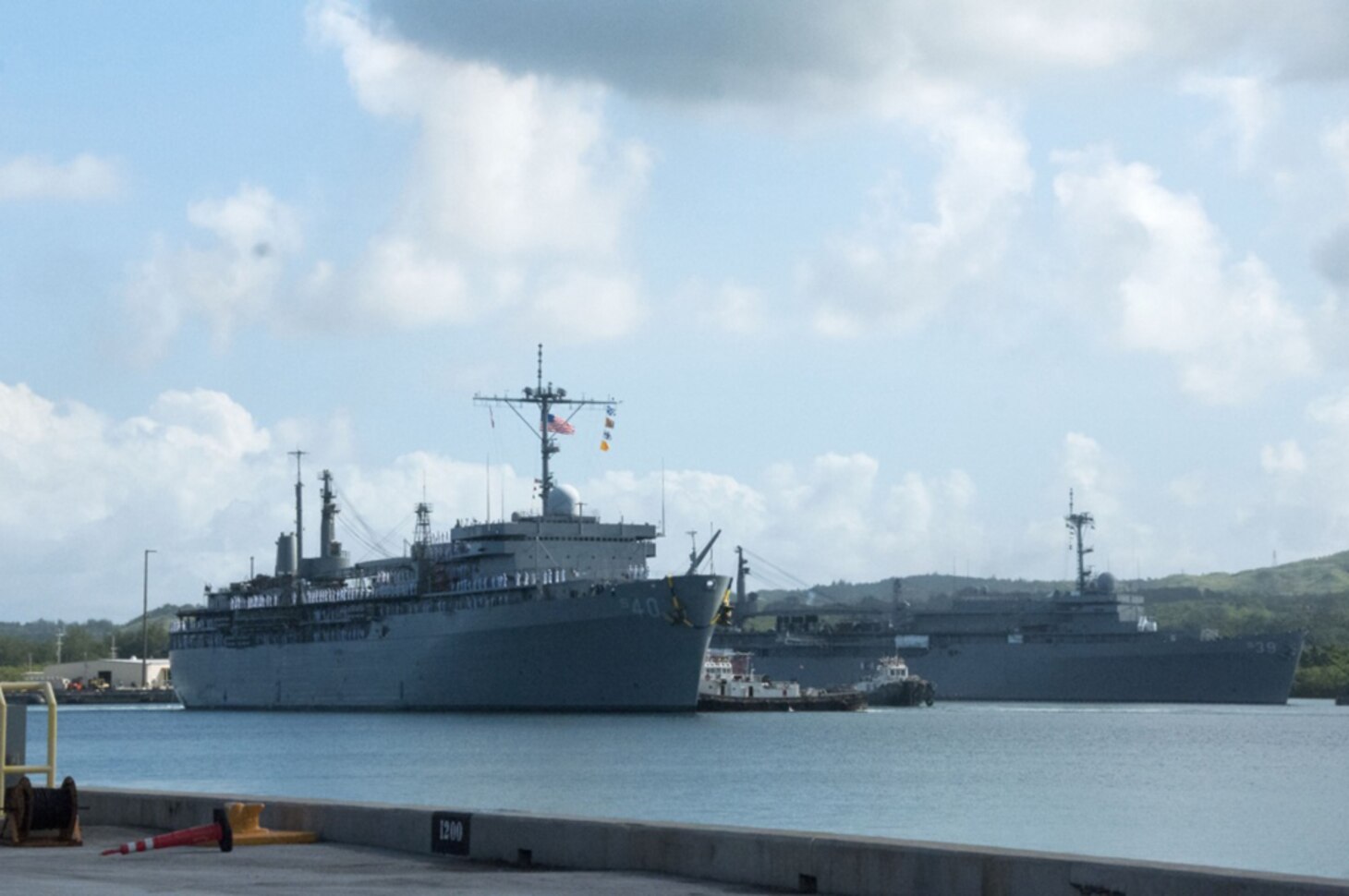 Submarine tender USS Frank Cable (AS 40) passes the U.S. Navy's only other submarine tender, USS Emory S. Land (AS 39), in Apra Harbor following Frank Cable's return to home port this morning after completing a five-month deployment, Nov, 8, 2016. Frank Cable departed Guam June 6 and was a persistent presence throughout the Indo-Asia-Pacific region during its deployment, providing vital flexibility to the fleet commanders and extending the range and impact of U.S. naval forces in the U.S. Navy's 5th and 7th Fleets. Forward deployed to Guam, Frank Cable's combined Navy and Military Sealift Command's crew's mission is to provide critical warfighting repairs, rearmament and reprovisioning to deployed naval forces of the United States. 