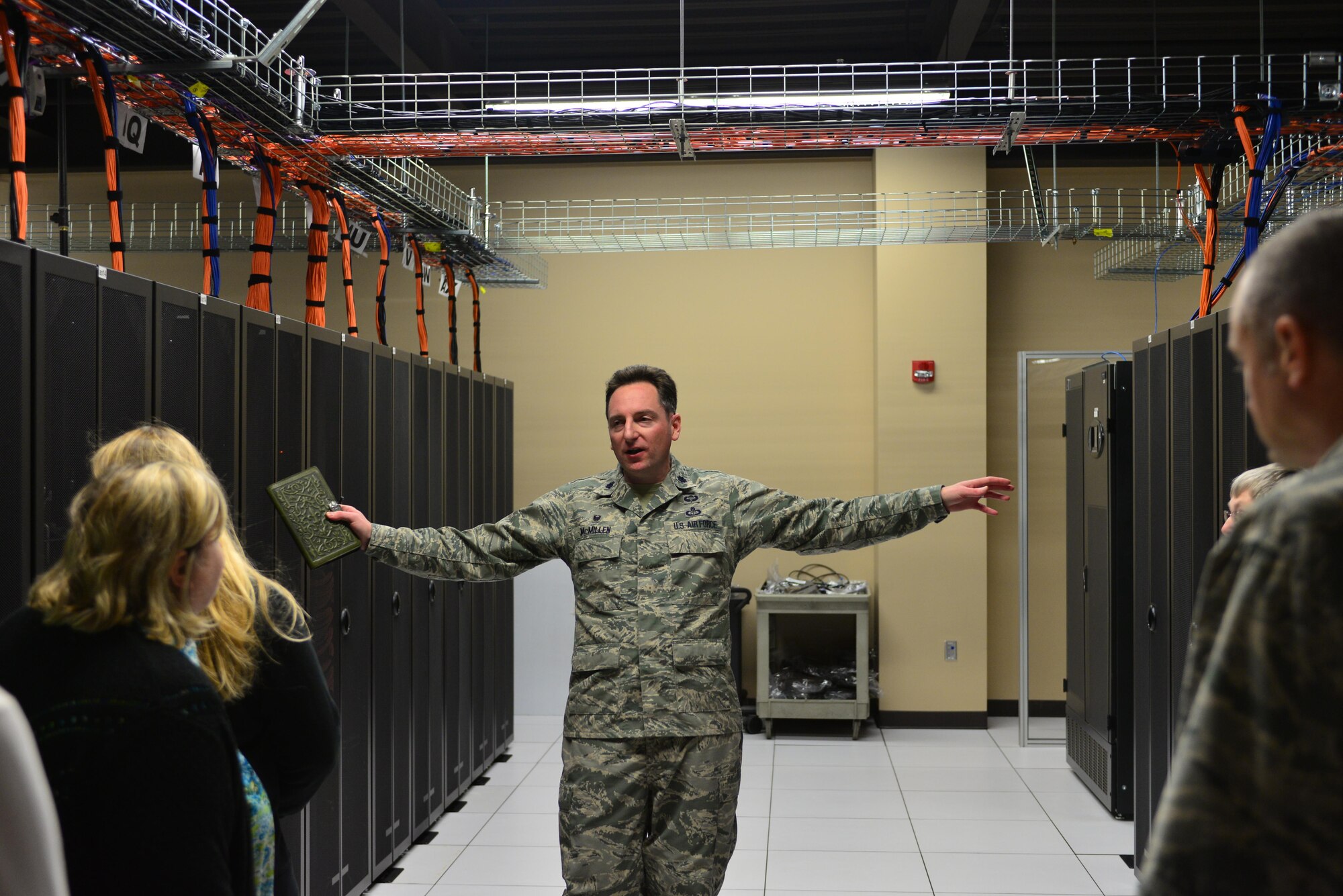 Lt. Col. John McMillen, commander of the 2nd Systems Operations Squadron, gives a tour of the  High-Performance Computing Center in the 557th Weather Wing at Offutt Air Force Base, Neb., to spouses and service members during the Spouses Town Hall Nov. 1, 2016. The town hall, which included briefings on the Key Spouses program, a meet and greet with wing leadership and a tour of the 557th WW facilities, gave spouses a greater understanding of the 557th WW mission. (U.S. Air Force photo/Senior Airman Rachel Hammes)
