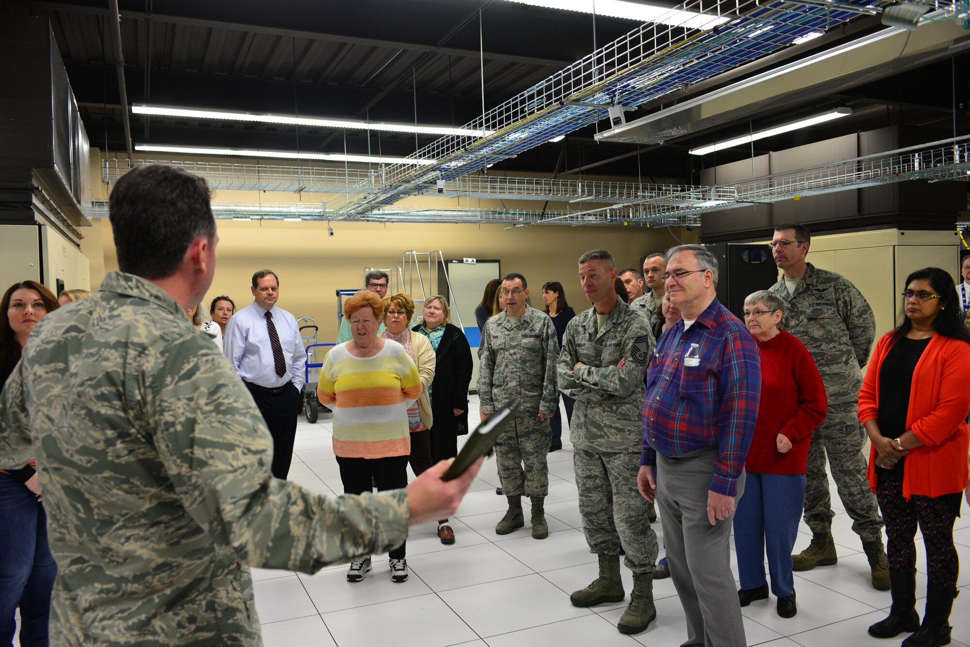 Service members and spouses take a tour of the High-Performance Computing Center in the 557th Weather Wing at Offutt Air Force Base, Neb., during the Spouses Town Hall Nov. 1, 2016. The town hall, which included briefings on the Key Spouses program, a meet and greet with wing leadership and a tour of the 557th WW facilities, gave spouses a greater understanding of the 557th WW mission. (U.S. Air Force photo/Senior Airman Rachel Hammes)