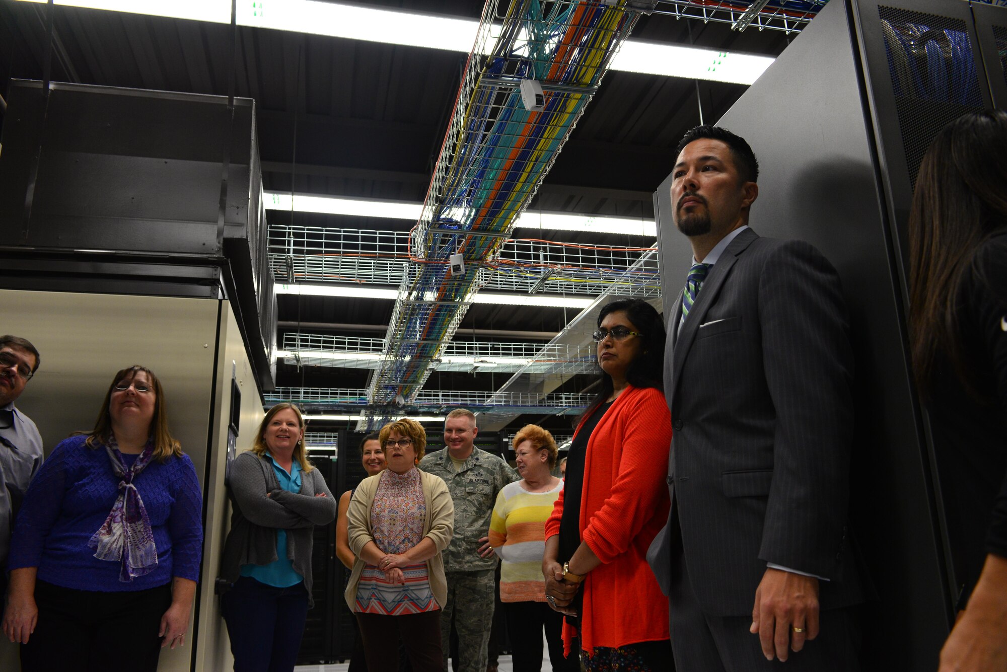 Service members and spouses take a tour of the High-Performance Computing Center in the 557th Weather Wing at Offutt Air Force Base, Neb., during the Spouses Town Hall Nov. 1, 2016. The town hall, which included briefings on the Key Spouses program, a meet and greet with wing leadership and a tour of the 557th WW facilities, gave spouses a greater understanding of the 557th WW mission. (U.S. Air Force photo/Senior Airman Rachel Hammes)