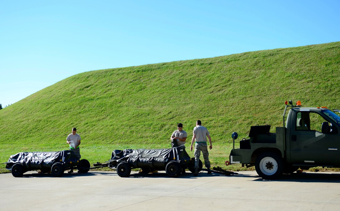 Airmen with the 1st Maintenance Squadron munitions flight prepare to unload munitions at Joint Base Langley-Eustis, Va., Oct. 21, 2016. The munitions flight is home to Airmen that have the opportunity to work in every part of the ammunition career field including assembly, testing and repairing ammunitions. (U.S. Air Force photo by Airman 1st Class Kaylee Dubois)