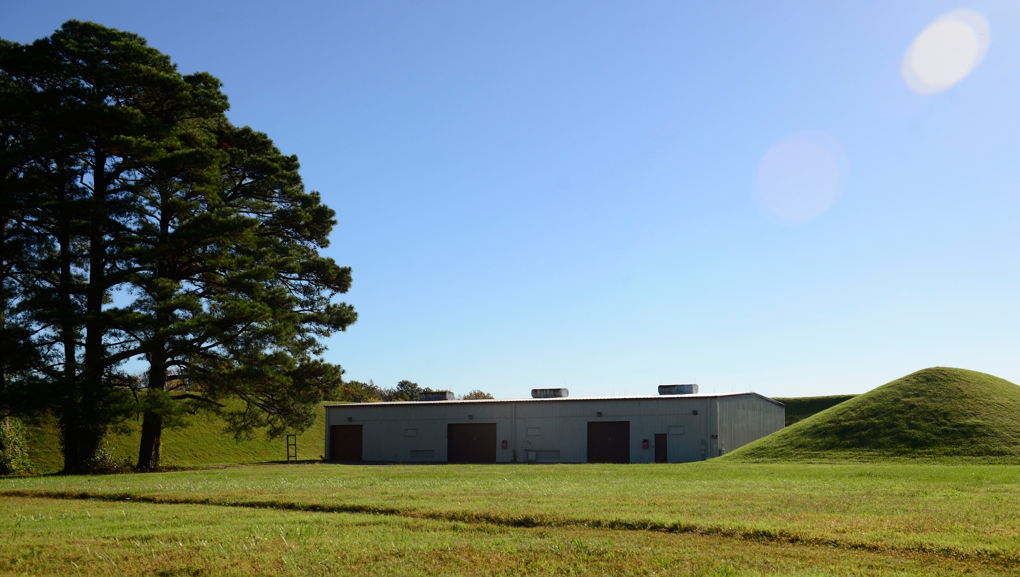 Hills surround buildings holding ammunition in ‘ammo country’ at Joint Base Langley-Eustis, Va., Oct. 21, 2016. The large mounds lighten the impact of the surrounding area in case of an inadvertent explosion of the stored munitions. (U.S. Air Force photo by Airman 1st Class Kaylee Dubois)