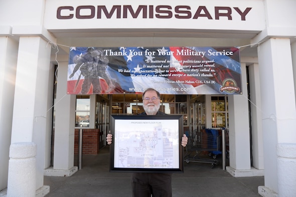Mr. James Freeman, commissary store director, stands in front of the commissary entrance displaying renovation floor plans at F.E. Warren Air Force base, Wyo., Nov. 8, 2016.  The commissary renovations will provide an enhanced shopping experience to customers and is scheduled to be completed in late 2018.