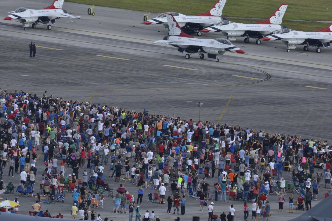 A crowd of people watch as the U.S. Thunderbirds prepare for takeoff during the Wings Over Homestead Air show at Homestead Air Reserve Base, Fla. Nov. 6. More than 100,000 people attended this year’s Air Show (U.S. Air Force photo by Senior Airman Aja Heiden)
