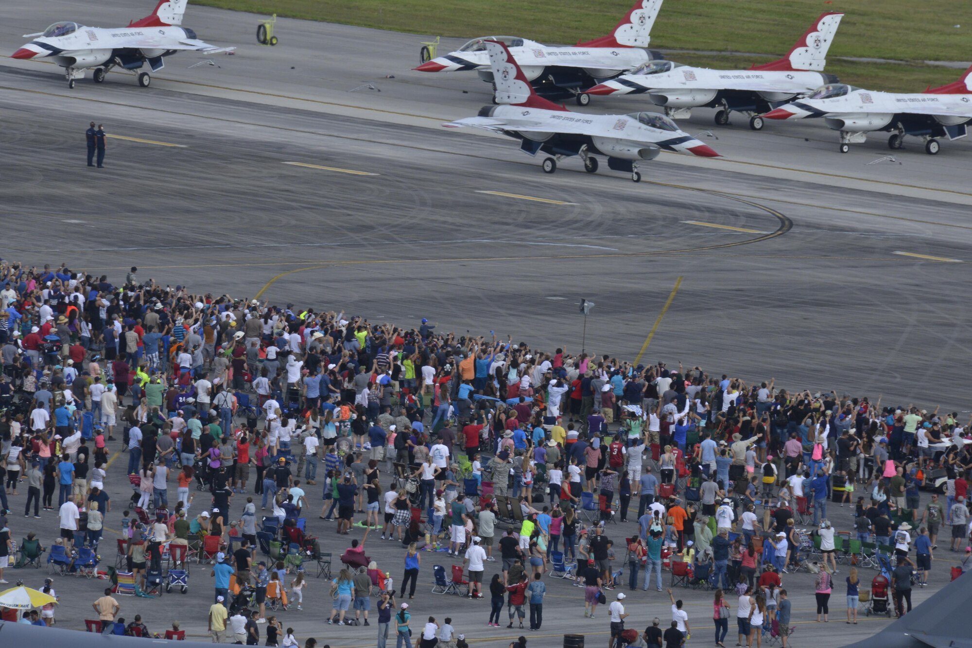 A crowd of people watch as the U.S. Thunderbirds prepare for takeoff during the Wings Over Homestead Air show at Homestead Air Reserve Base, Fla. Nov. 6. More than 100,000 people attended this year’s Air Show (U.S. Air Force photo by Senior Airman Aja Heiden)