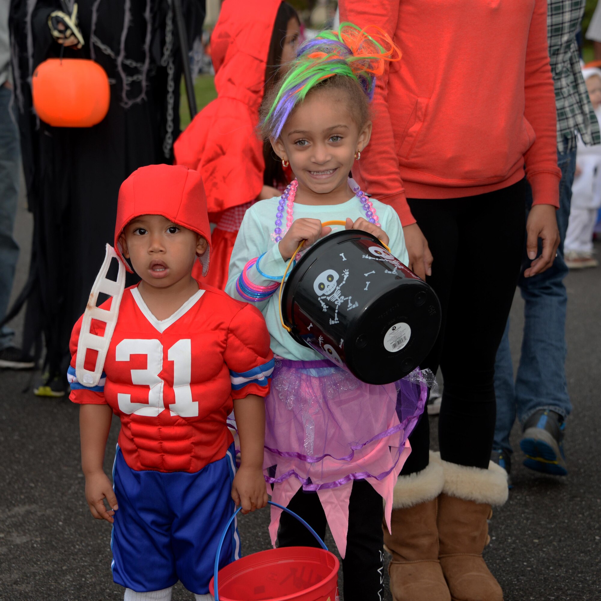 Children wait in line with their families at the 5th Annual Trunk-or-Treat event at Travis Air Force Base, Calif., Oct. 28, 2016. More than 2,000 people attended the event which provided a safe place for military families to enjoy Halloween festivities. (U.S. Air Force photo/Tech. Sgt. James Hodgman) 
