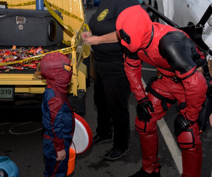 A volunteer in a Deadpool costume (Right) greets a young Spiderman (Left) during the 5th Annual Trunk-or-Treat event at Travis Air Force Base, Calif., Oct. 28, 2016. More than 2,000 people attended the event which provided a safe place for military families to enjoy Halloween festivities. (U.S. Air Force photo/Tech. Sgt. James Hodgman) 