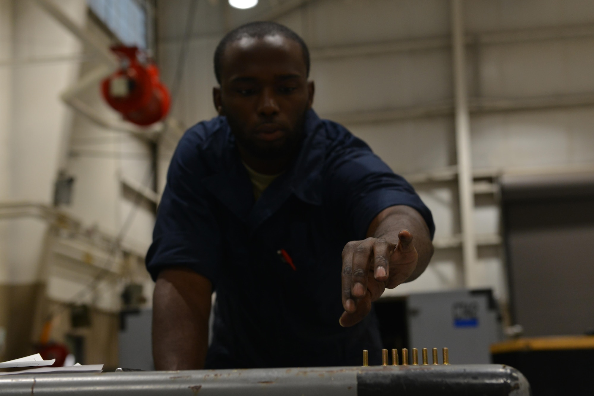 U.S. Air Force Senior Airman Desmond Wells, 20th Equipment Maintenance Squadron aerospace ground equipment journeyman, reaches for a bolt at Shaw Air Force Base, S.C., Nov. 2, 2016. New bolts were used to repair a munitions loader, which is used to load and unload missiles from an F-16CM Fighting Falcon. (U.S. Air Force photo by Airman 1st Class Destinee Sweeney)
